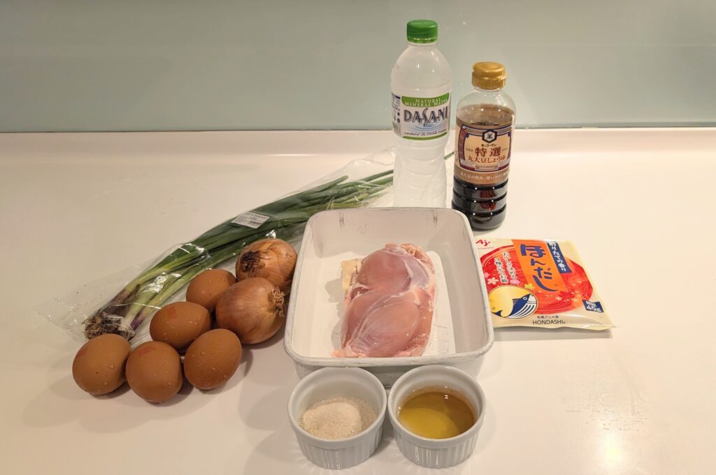 Ingredients for halal oyakodon including chicken thighs eggs onion soy sauce and dashi