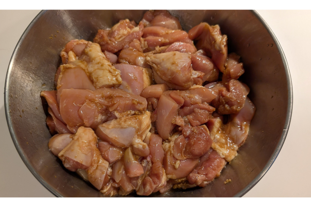 Chicken marinating in soy sauce for halal chicken karaage